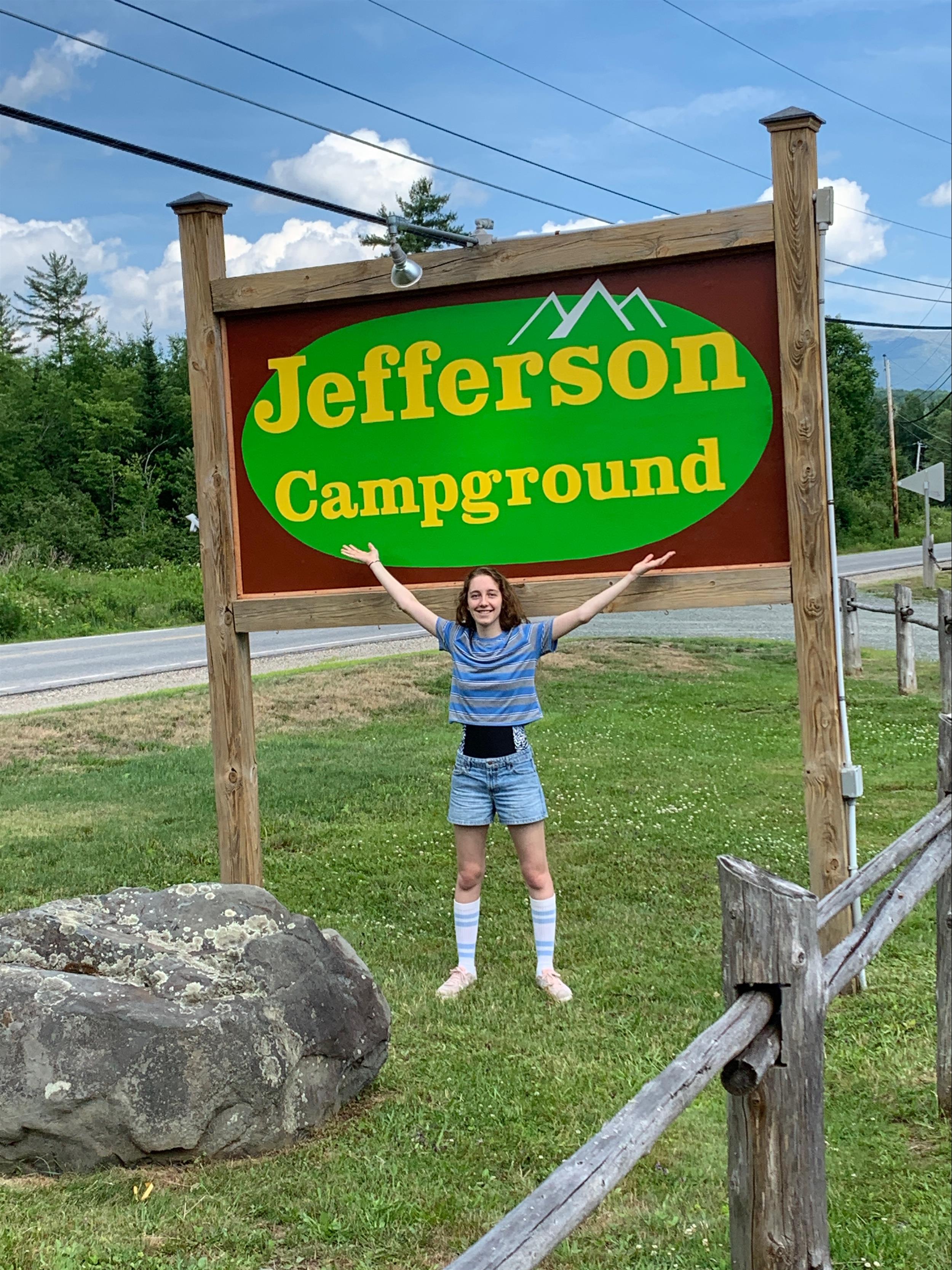 Girl presenting campground sign
