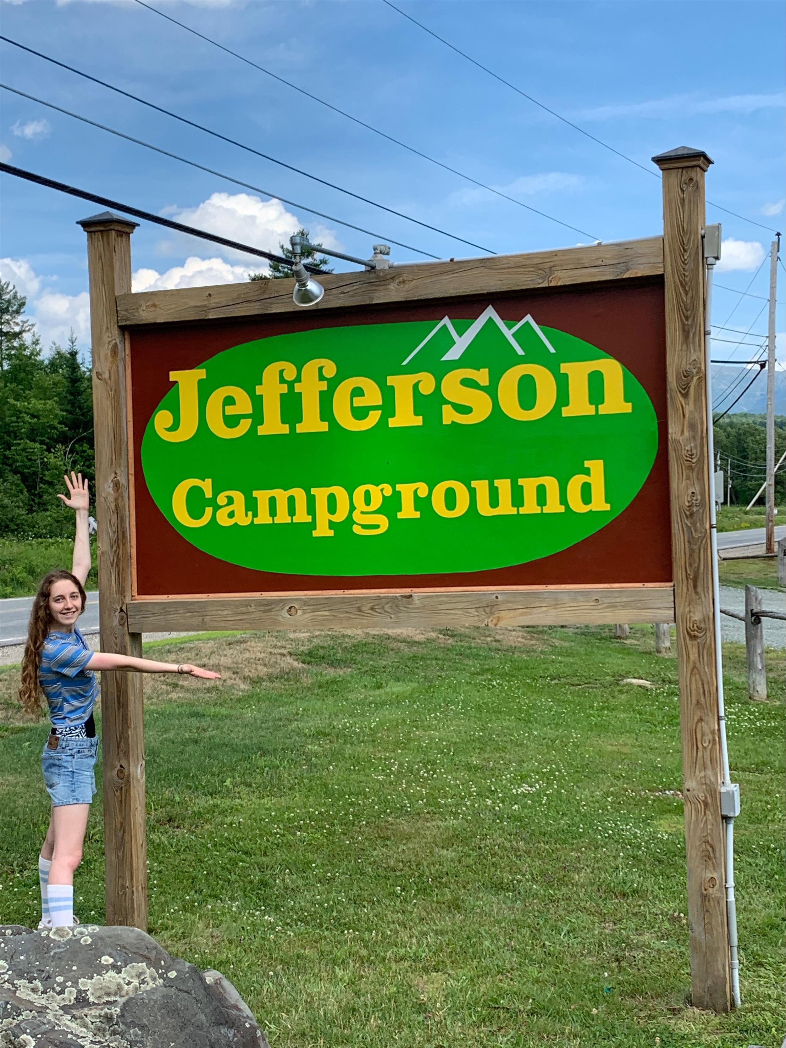 Girl presenting campground sign